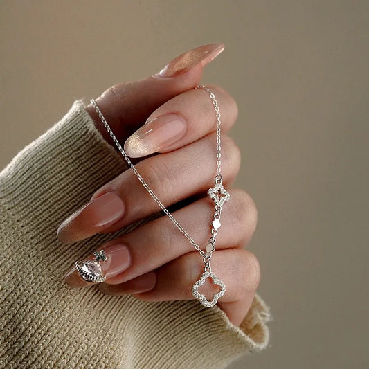 Sterling Silver Hollow Four-Leaf Flower Necklace worn to showcase its length and pendant detail