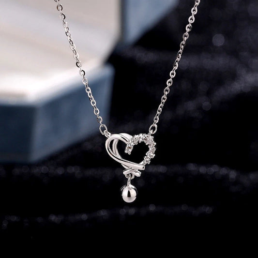 Sterling Silver Hollow Heart Necklace worn to showcase its length and pendant detail