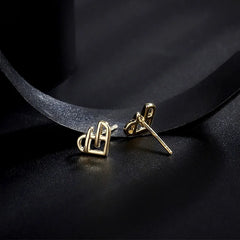 Angled view of the Sterling Silver Hollow Heart Stud Earrings