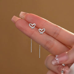 Angled view of the Sterling Silver Hollow Heart Threader Earrings