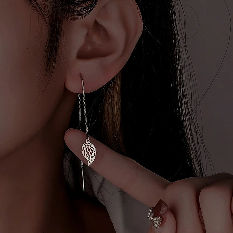 Model showcasing the dangle and style of the Sterling Silver Hollow Leaf Threader Earrings