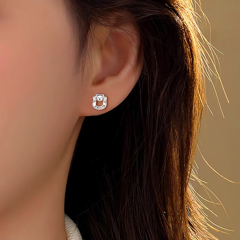 Model showcasing the dangle and style of the Sterling Silver Hollow Letter Bear Earrings