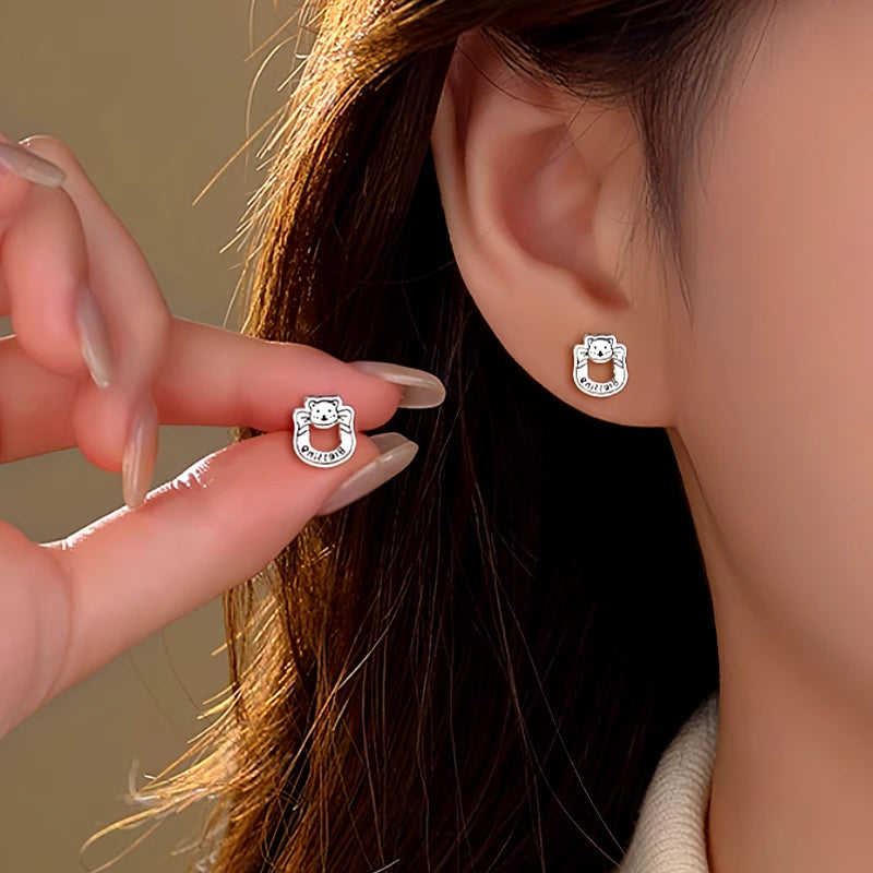 Angled view of the Sterling Silver Hollow Letter Bear Earrings