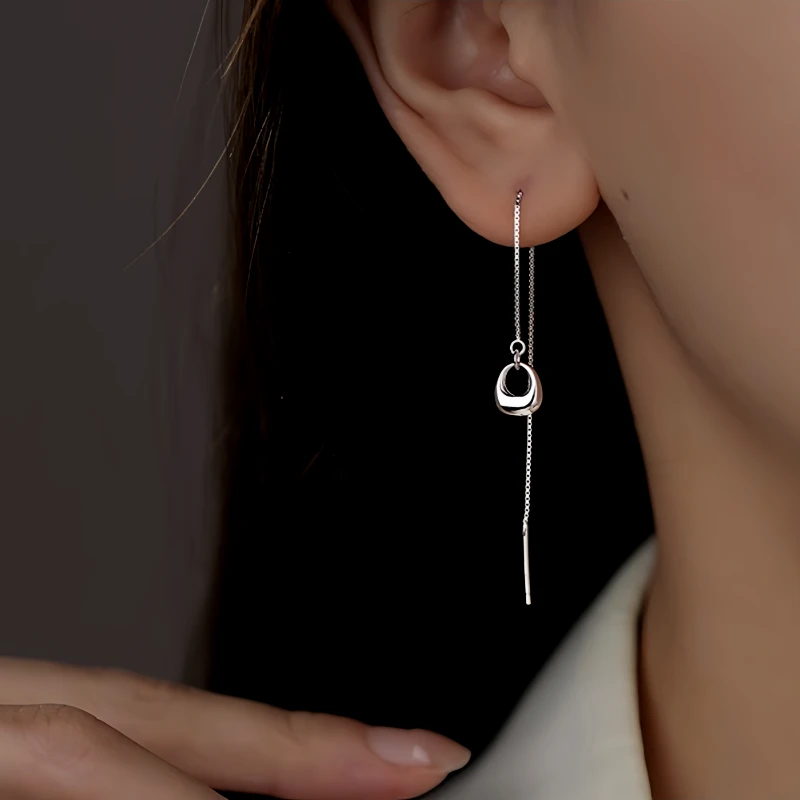 Model showcasing the dangle and style of the Sterling Silver Hollow Oval Threader Earrings