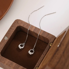 Angled view of the Sterling Silver Hollow Oval Threader Earrings