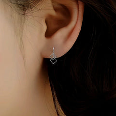 Model showcasing the dangle and style of the Sterling Silver Hollow Square Threader Earrings