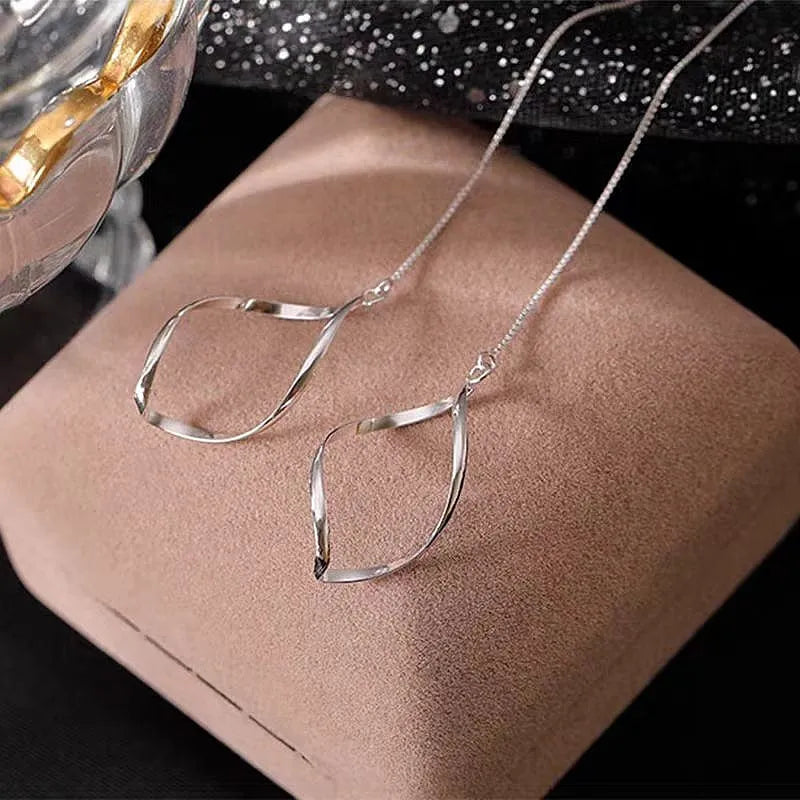 Angled view of the Sterling Silver Hollow Wavy Leaf Threader Earrings