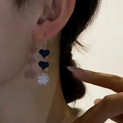 Model showcasing the dangle and style of the Sterling Silver Ice Crystal Heart Threader Tassel Earrings