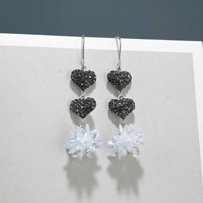 Angled view of the Sterling Silver Ice Crystal Heart Threader Tassel Earrings
