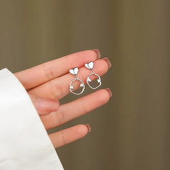 Angled view of the Sterling Silver Irregular Hoop Heart Earrings
