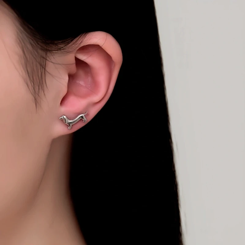 Model showcasing the dangle and style of the Sterling Silver Little Puppy Stud Earrings