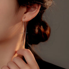 Model showcasing the dangle and style of the Sterling Silver Long Cross Threader Earrings