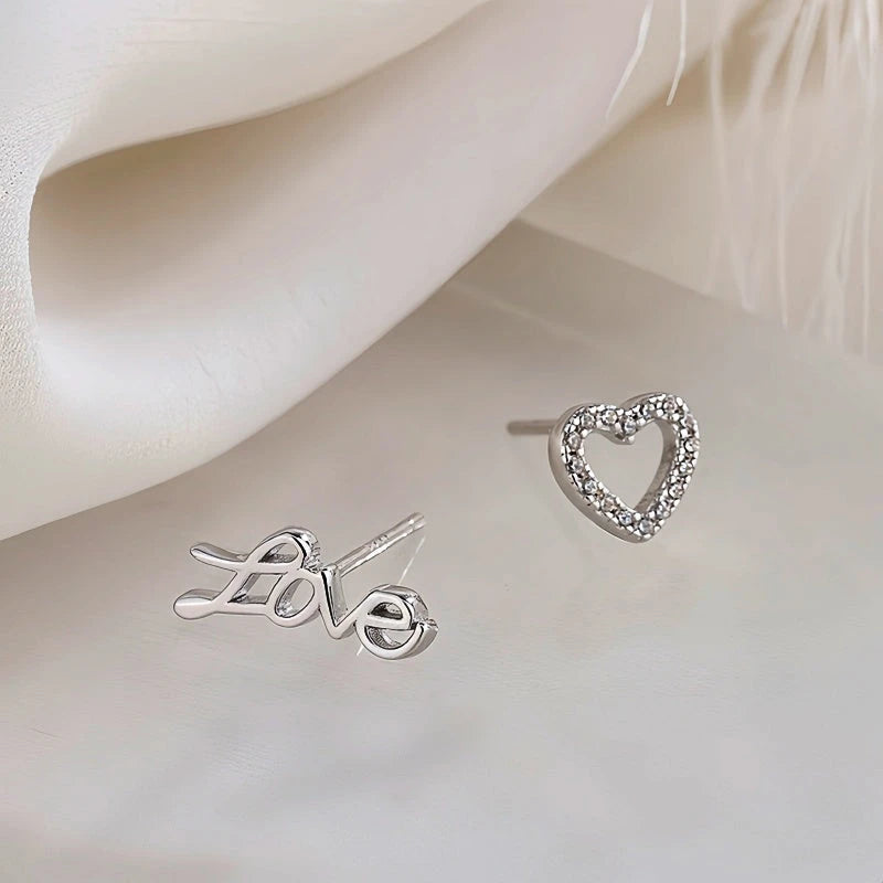 Model showcasing the dangle and style of the Sterling Silver Love Asymmetrical Stud Earrings