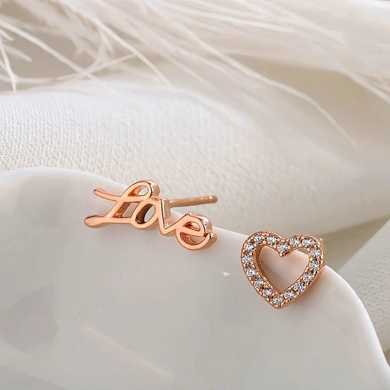 Angled view of the Sterling Silver Love Asymmetrical Stud Earrings
