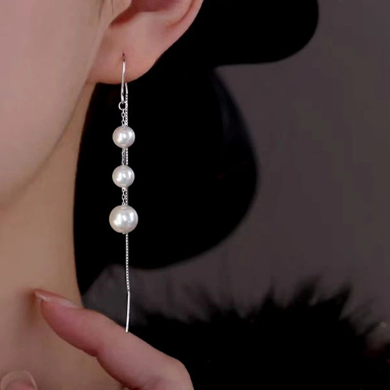 Model showcasing the dangle and style of the Sterling Silver Luxury Artificial Pearl Tassel Threader Earrings