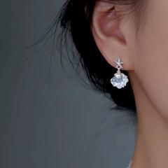 Model showcasing the dangle and style of the Sterling Silver Luxury Starfish Shell Pearl Earrings