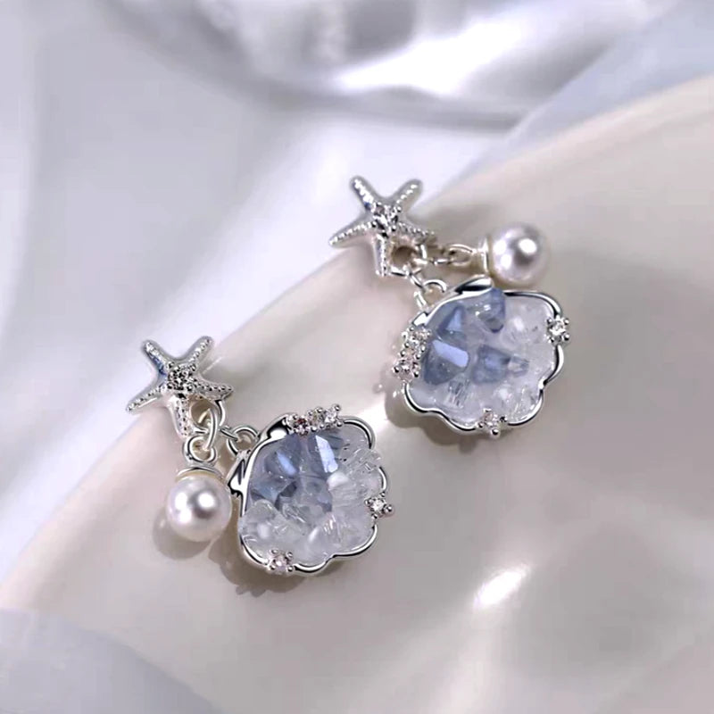 Angled view of the Sterling Silver Luxury Starfish Shell Pearl Earrings