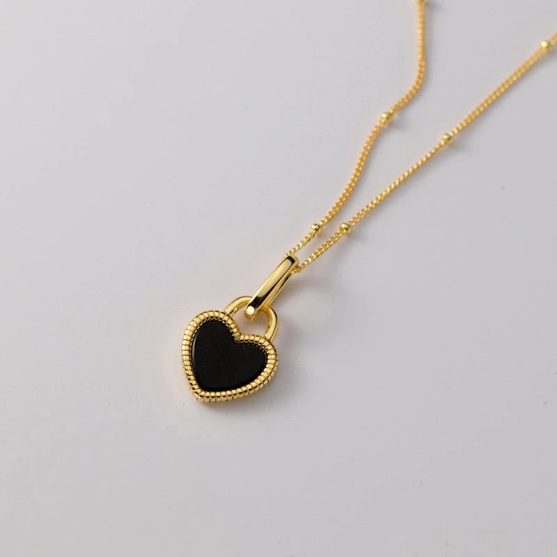 Close-up of the pendant and clasp on the Black and White Heart Necklace