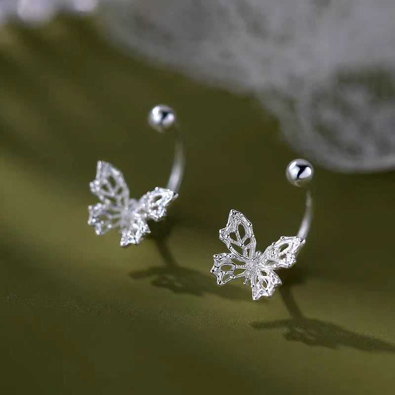 Model showcasing the dangle and style of the Sterling Silver Luxury Zircon Butterfly Screw Jacket Earrings