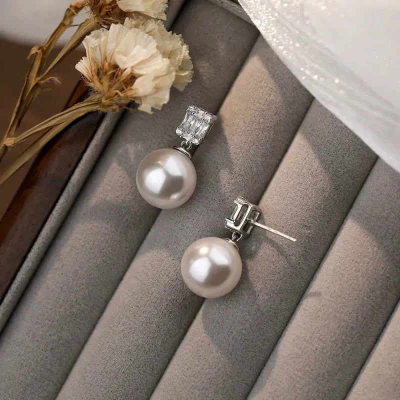 Angled view of the Sterling Silver Luxury Zircon Diamond Pearl Earrings