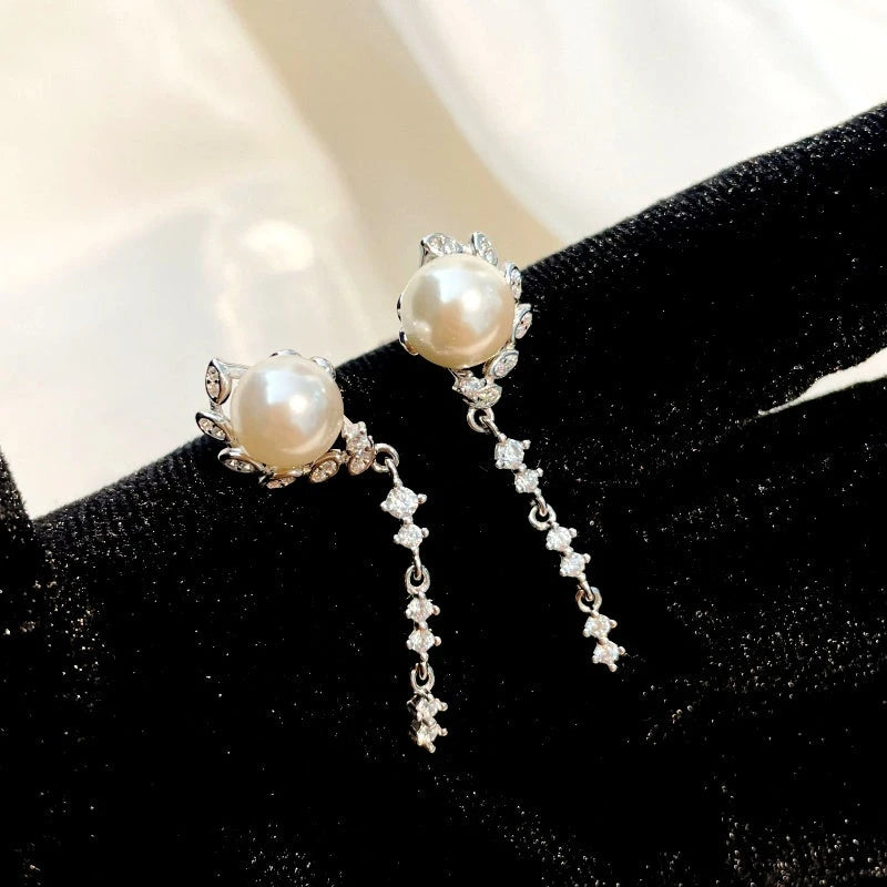 Close-up detail of the sparkling zircons and plating on the Pearl and Leaf Earrings
