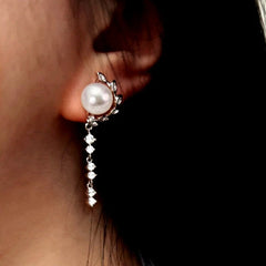 Model showcasing the dangle and style of the Sterling Silver Luxury Zircon Leaf Pearl Earrings