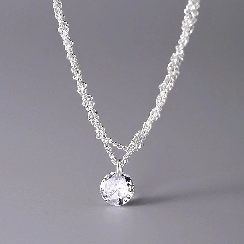 Close-up of the pendant and clasp on the Braided Chain Necklace