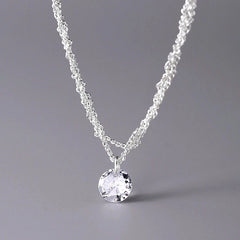 Close-up of the pendant and clasp on the Braided Chain Necklace