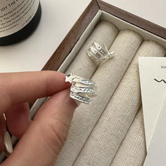 Model showcasing the dangle and style of the Sterling Silver Multi-Layer Arc Design Stud Earrings