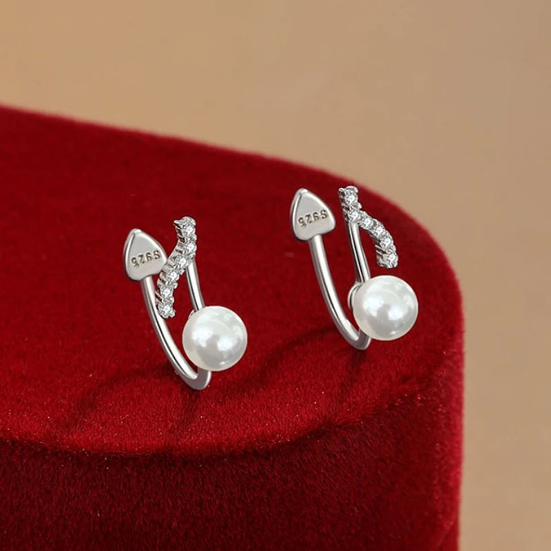 Model showcasing the dangle and style of the Sterling Silver Note Pearl Ear Clips