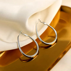Angled view of the Sterling Silver Oval Hoop Earrings