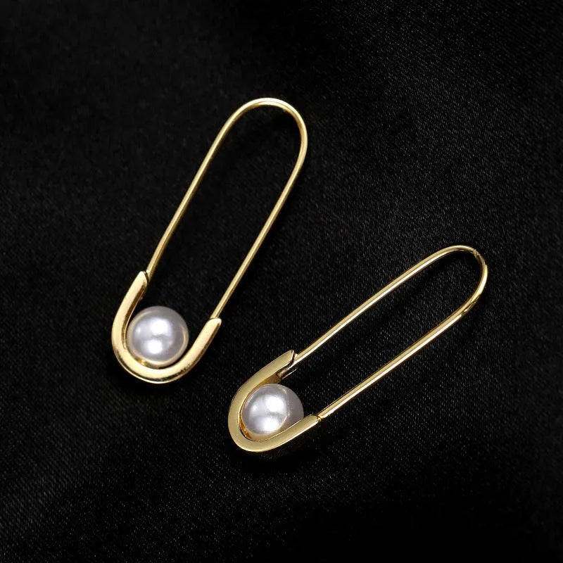 Close-up detail of the sparkling zircons and plating on the Paper Clip Pearl Earrings
