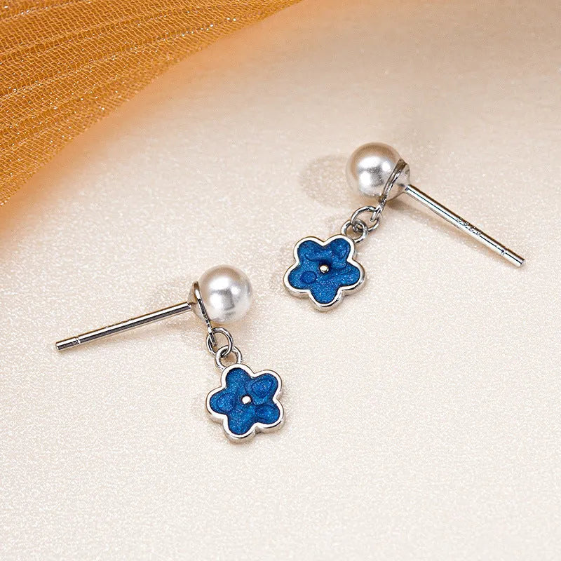 Close-up detail of the sparkling zircons and plating on the Blue Flower Earrings