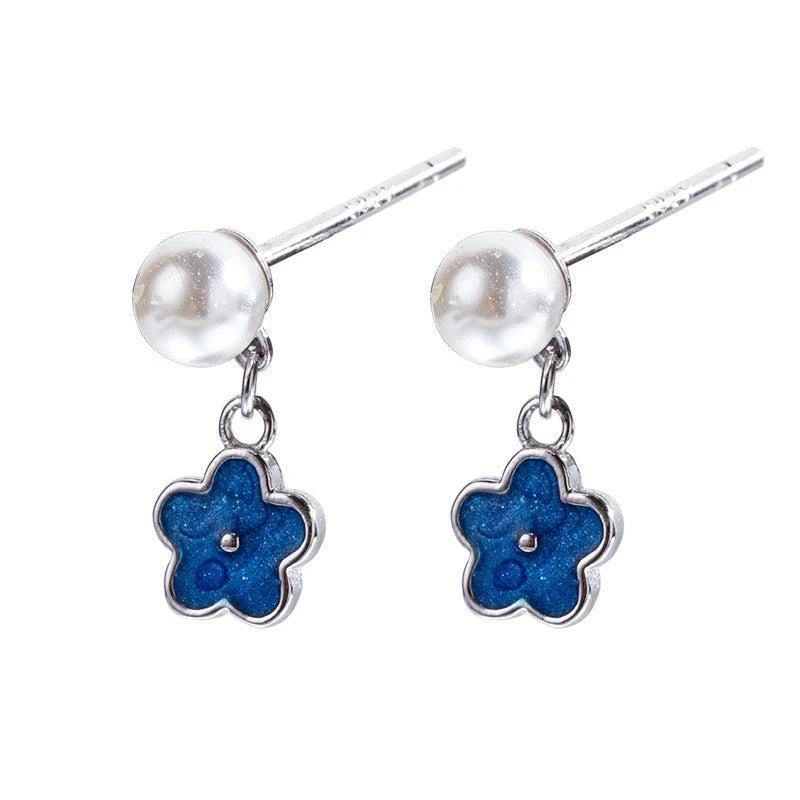 Angled view of the Sterling Silver Pearl Blue Flower Earrings