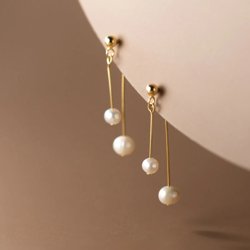 Close-up detail of the sparkling zircons and plating on the Pearl Cross Earrings
