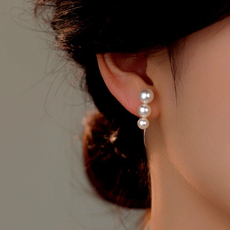 Model showcasing the dangle and style of the Sterling Silver Pearl Ear Hook Earrings
