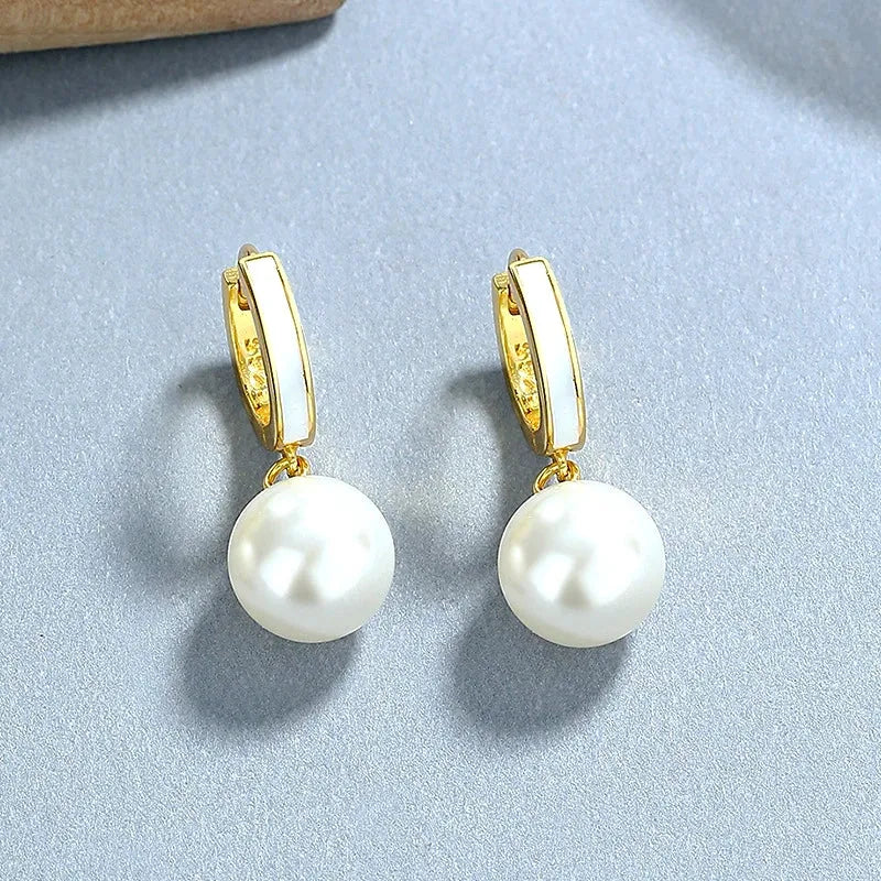 Model showcasing the dangle and style of the Sterling Silver Pearl Earrings