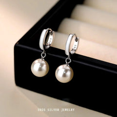 Close-up detail of the sparkling zircons and plating on the Classic Pearl Dangle Earrings