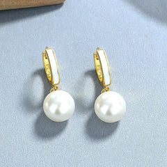 Model showcasing the dangle and style of the Sterling Silver Pearl Earrings