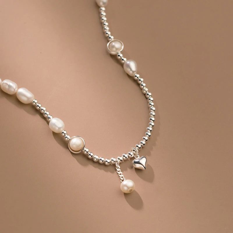 Close-up of the pendant and clasp on the Pearl Heart Necklace
