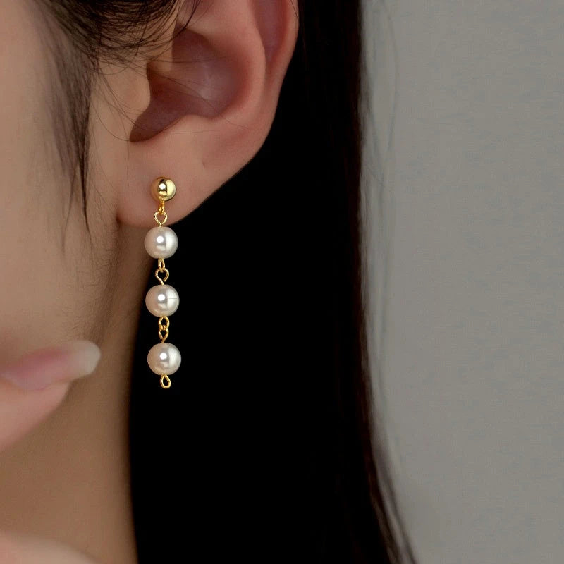 Model showcasing the dangle and style of the Sterling Silver Pearl Tassel Earrings