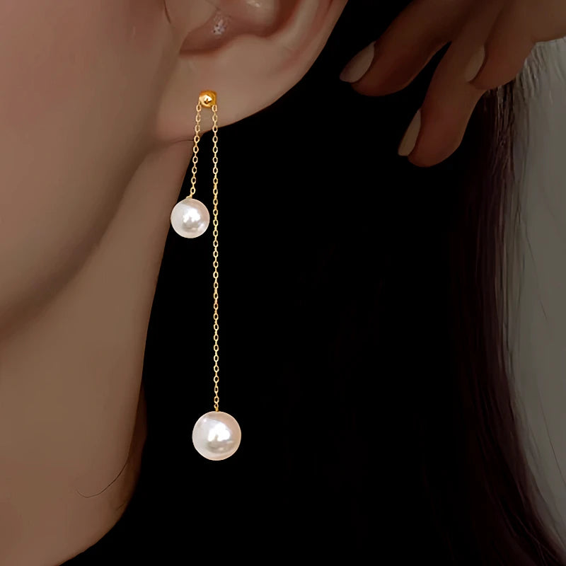 Model showcasing the dangle and style of the Sterling Silver Pearl Tassel Earrings