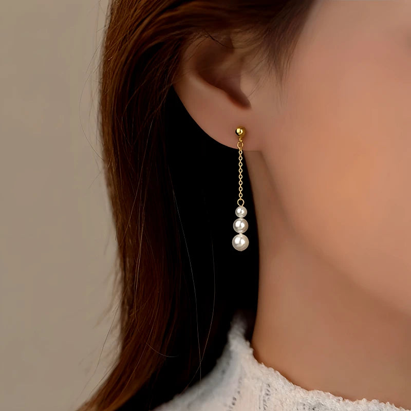 Model showcasing the dangle and style of the Sterling Silver Pearl Tassel Earrings