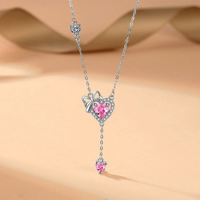 Sterling Silver Pink Diamond Hear Bow Earrings And Necklace Set worn to showcase its length and pendant detail