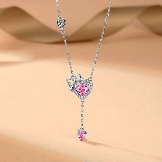 Sterling Silver Pink Diamond Hear Bow Earrings And Necklace Set worn to showcase its length and pendant detail