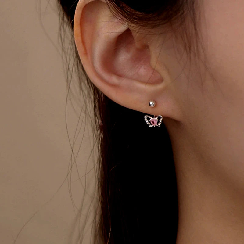 Angled view of the Sterling Silver Pink Diamond Heart Butterfly Screw Earrings