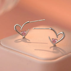 Model showcasing the dangle and style of the Sterling Silver Pink Diamond Heart Earrings