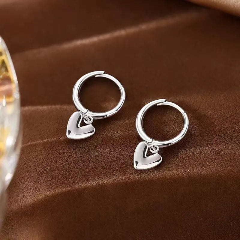 Close-up detail of the sparkling zircons and plating on the Polished Heart Earrings
