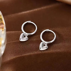 Close-up detail of the sparkling zircons and plating on the Polished Heart Earrings
