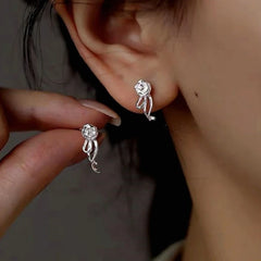 Model showcasing the dangle and style of the Sterling Silver Rose Flower Earrings